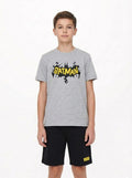 Child wearing a gray t-shirt with a Batman logo on a white background