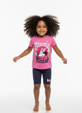 Child wearing a pink Minnie Mouse shirt and navy shorts on a white background