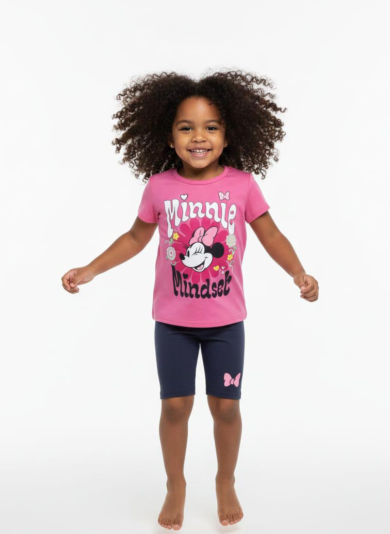 Child wearing a pink Minnie Mouse shirt and navy shorts on a white background